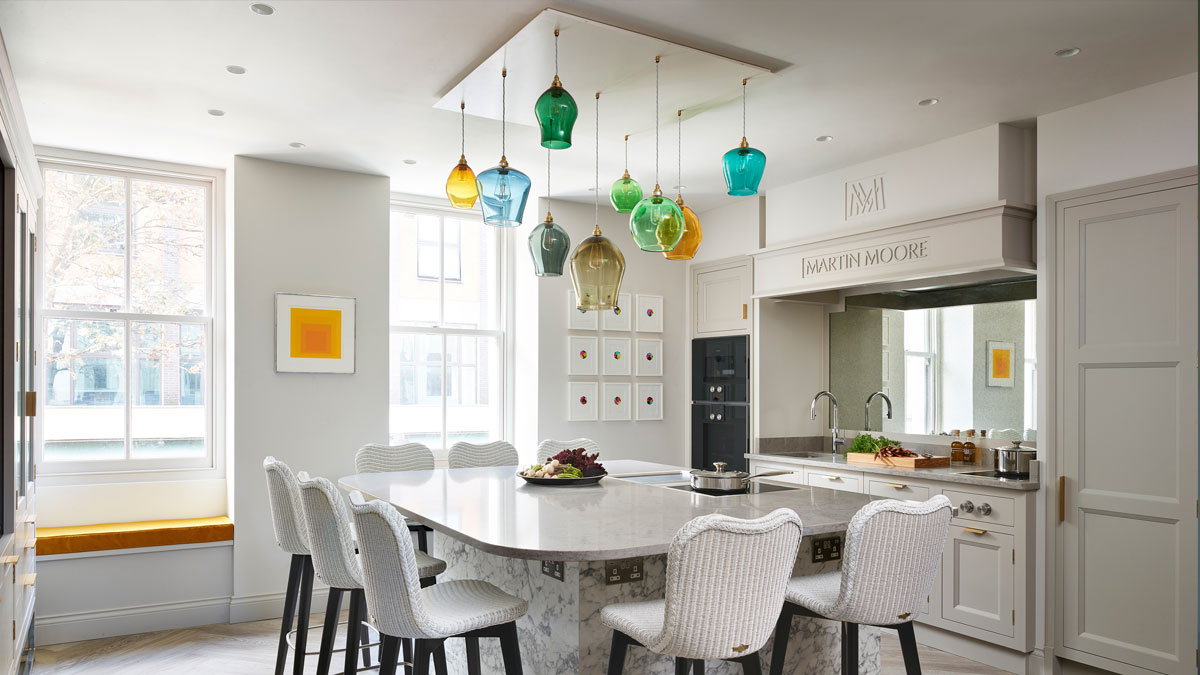 Statement hand-blown glass pendant chandelier over large kitchen island in the showcase kitchen of Michelin starred restaurant Pied à Terre.