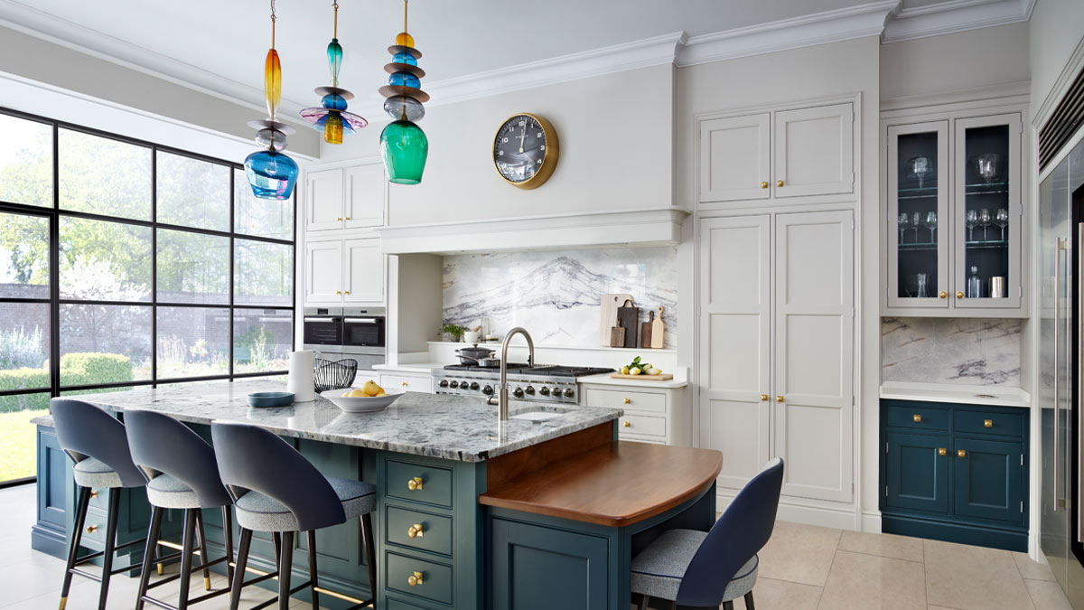 Hand-blown glass sculptural pendant light trio over shaker style kitchen island designed by Martin Moore